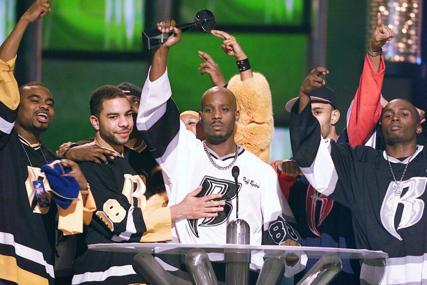 FILE - DMX, center, accepts the R&B Album Artist of the Year during the 1999 Billboard Music Awards in Las Vegas, on Dec. 8, 1999. The family of rapper DMX says he has died at age 50 after a career in which he delivered iconic hip-hop songs such as “Ruff Ryders’ Anthem." A statement from the family says the Grammy-nominated rapper died at a hospital in White Plains, New York, "with his family by his side" after being placed on life support for the past few days. He was rushed to a New York hospital from his home April 2. (AP Photo/Laura Rauch, File)
