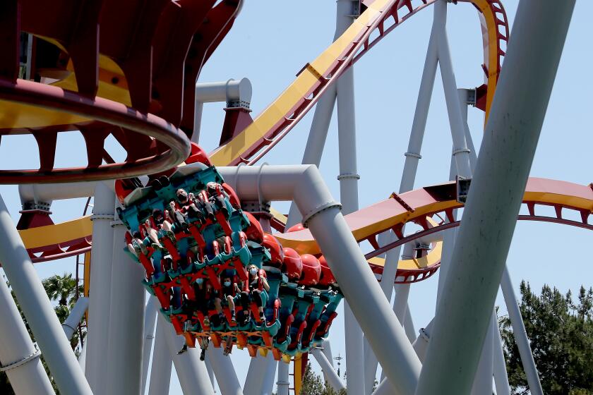 BUENA PARK, CA - MAY 06:. Visitors enjoy a thrill ride as Knott's Berry Farm reopened to season passholders on Thursday, May 6, 2021. The famed amusement park has been closed for more than a year because of the coronavirus pandemic lockdown, but plans to reopen to the general public on May 21. The number of visitors will be limited and parkgoers must follow safety protocols, including wearing masks and social distancing. (Luis Sinco / Los Angeles Times)