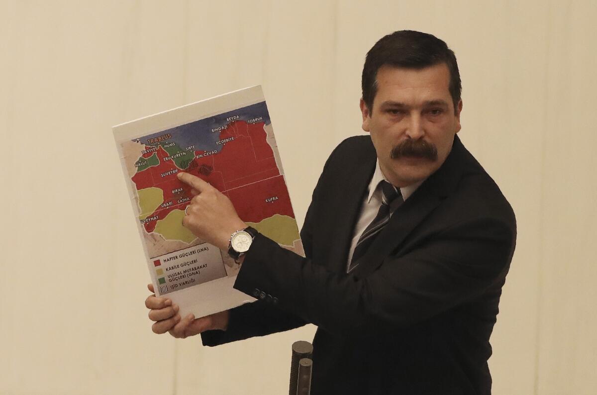 Erkan Bas, a lawmaker of the opposition Workers' Party, shows a map of divided Libya before Turkey's parliament authorized the deployment of troops to that country.