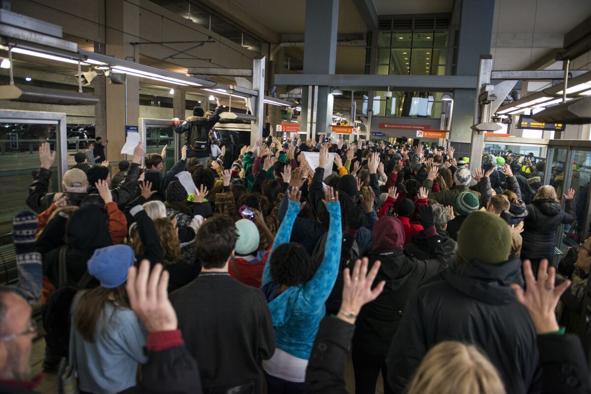 Black Lives Matter activists chant, "Hands up, don't shoot," at the Minneapolis-St. Paul International airport light-rail stop.