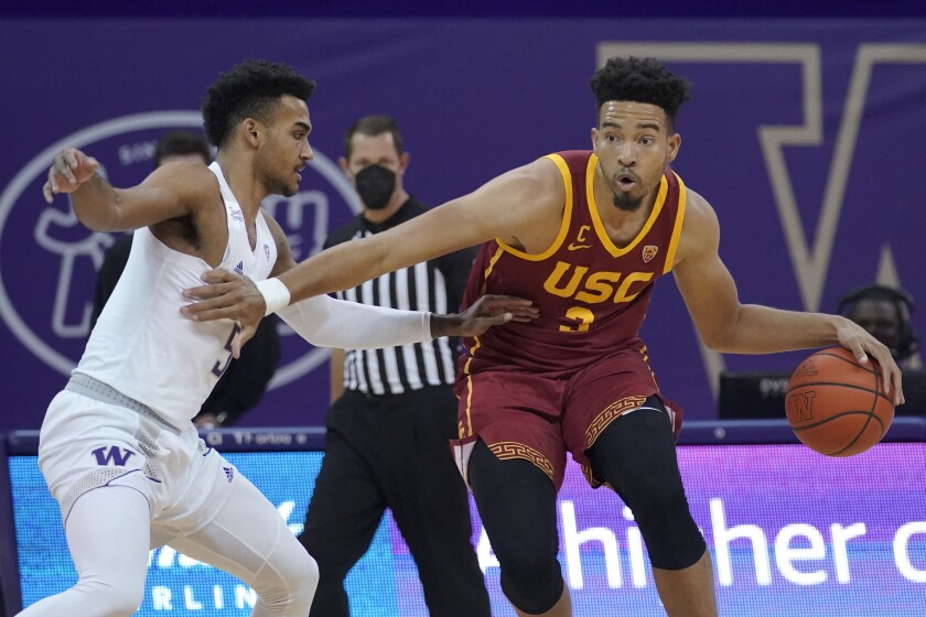 USC forward Isaiah Mobley tries to drive around Washington guard Jamal Bey.