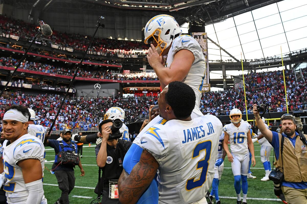 Derwin James Jr. hoists Cameron Dicker after the kicker made the Chargers' game-winning field goal against Atlanta. 
