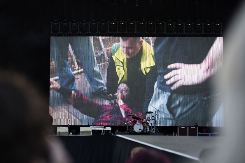 Dave Grohl is seen on a big screen after falling from the stage during a Foo Fighters concert in Sweden on Friday.