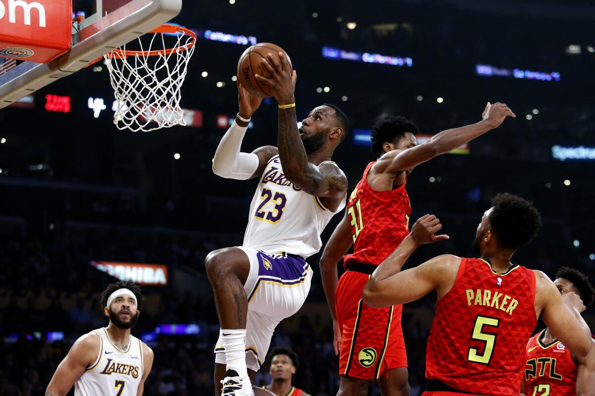 Lakers forward LeBron James shoots over Atlanta Hawks center Damian Jones.