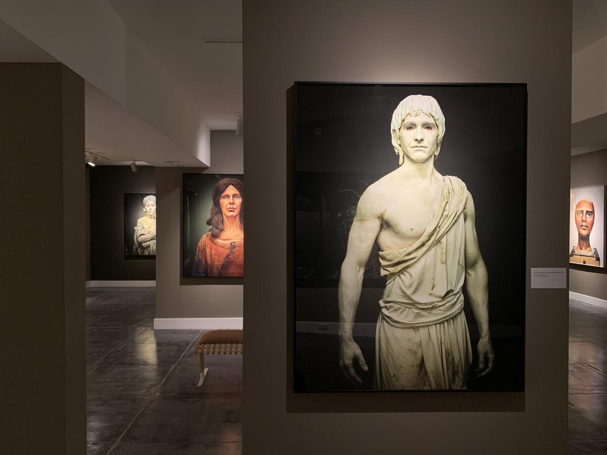 A gallery with photos of people decorated as sculptures