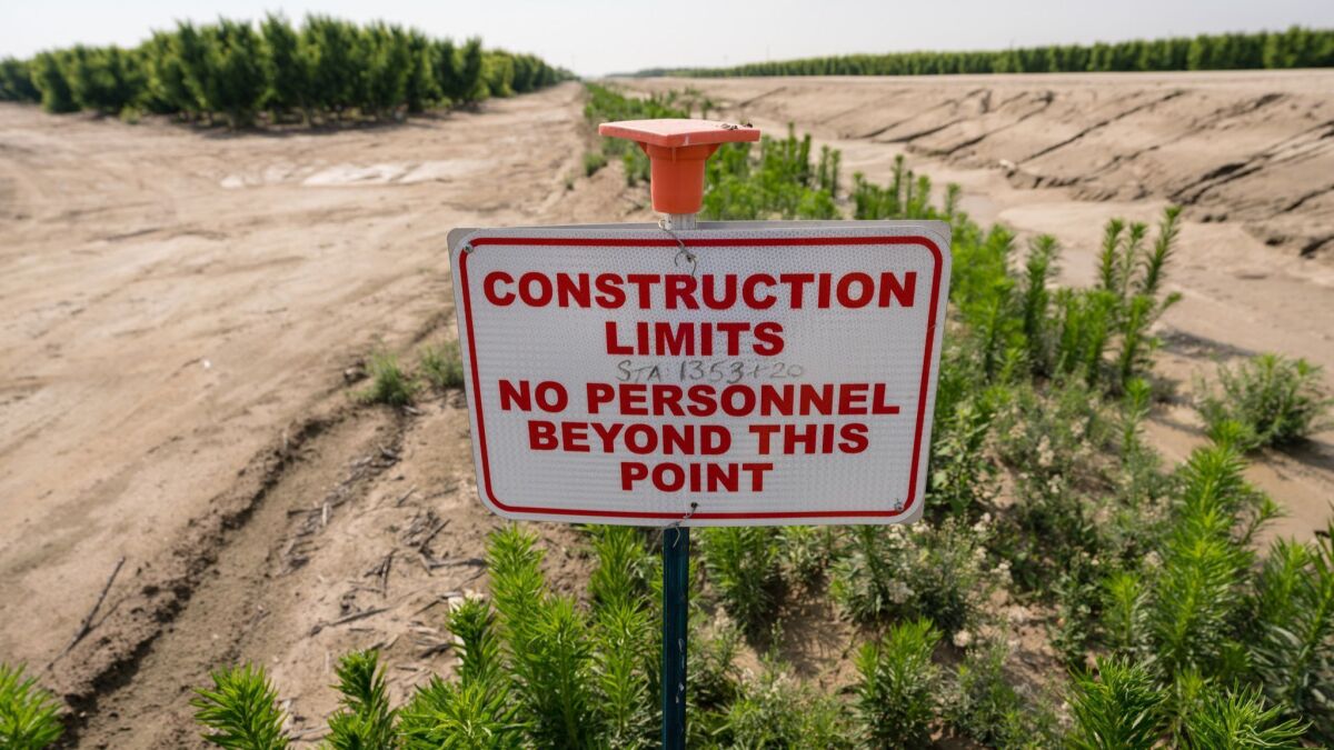 A sign stands next to land cleared for the bullet train. Farmer John Diepersloot says the state high-speed rail authority hasn't paid him for wells he had to relocate, fruit trees he had to remove and other costs.