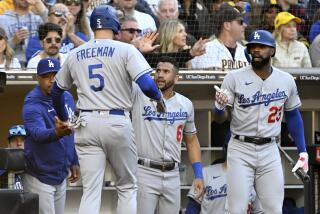 Los Angeles Dodgers' Freddie Freeman (5) celebrates with manager Dave Roberts, left, David Peralta.