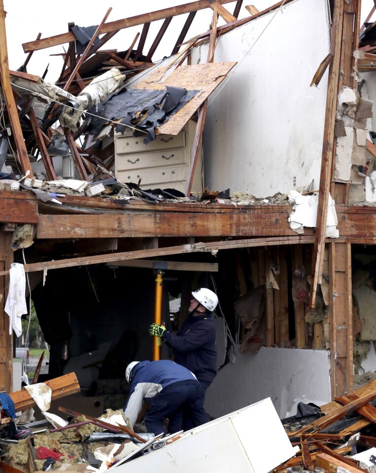 Firefighters set a brace to support a beam during a search-and-rescue operation at an apartment complex destroyed by an explosion at a fertilizer plant in West, Texas.