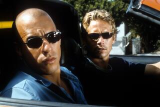 Vin Diesel and Paul Walker looking from car in a scene from the film 'The Fast And The Furious', 2001. (Photo by Universal/Getty Images)