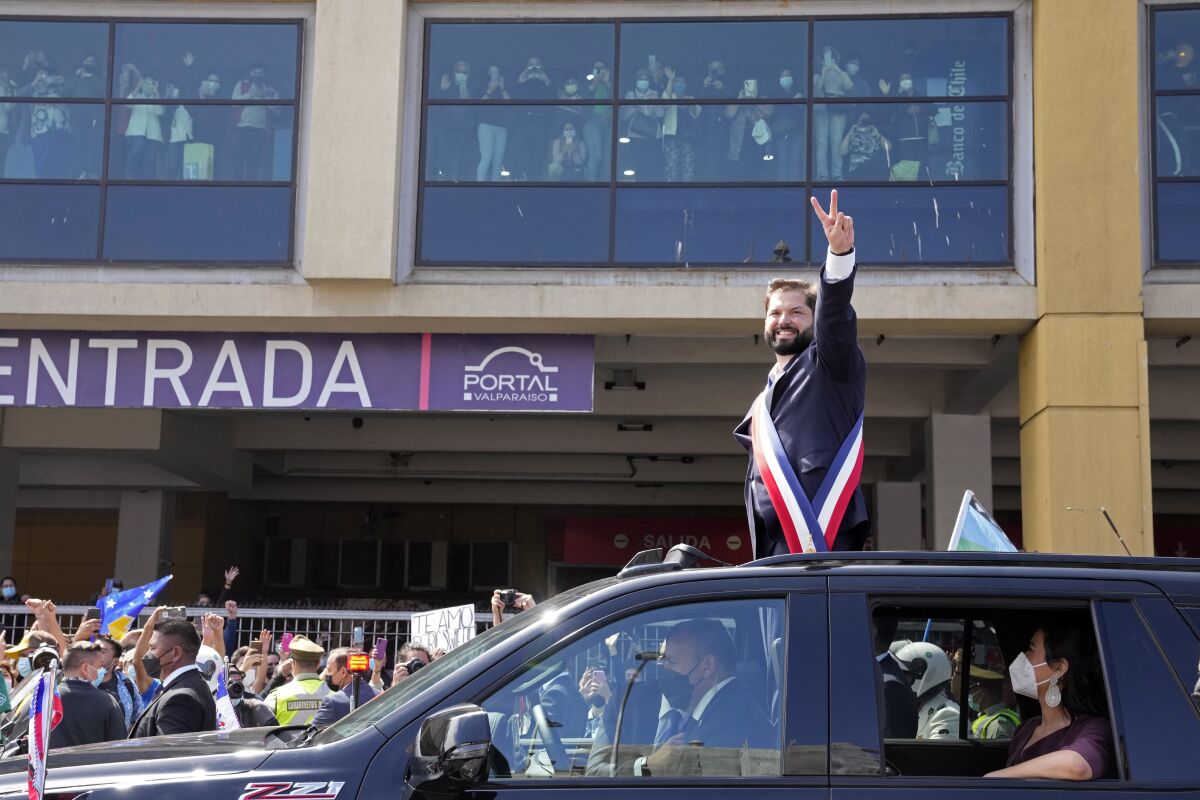 Chile's new President Gabriel Boric flashes a victory sign on his inauguration day after his swearing-in ceremony at Congress in Valparaiso, Chile, Friday, March 11, 2022. (AP Photo/Natacha Pisarenko)