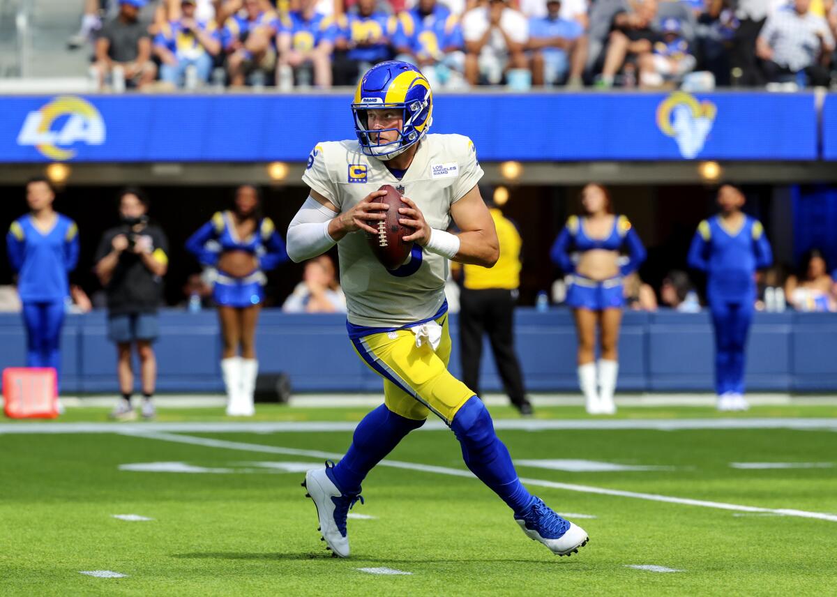 Rams quarterback Matthew Stafford rolls out for a pass against the Atlanta Falcons on Sept. 18.