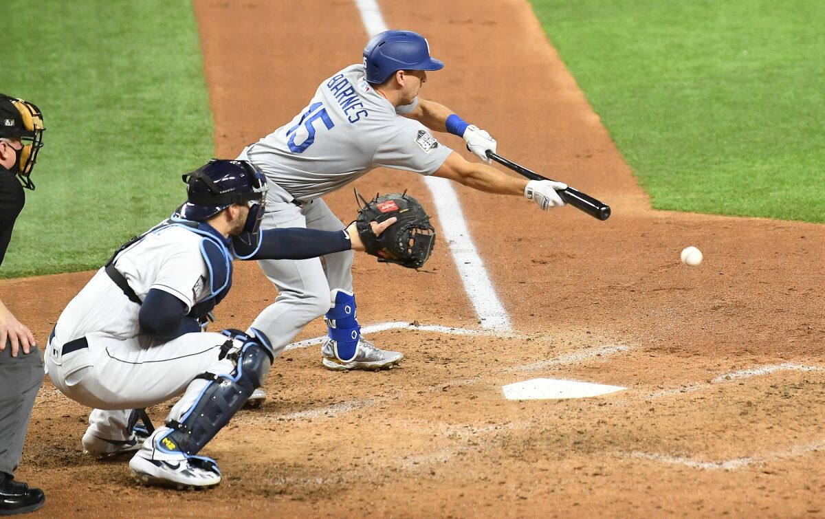 Dodgers catcher Austin Barnes lays down a bunt during Game 3 of the World Series against the Tampa Bay Rays.