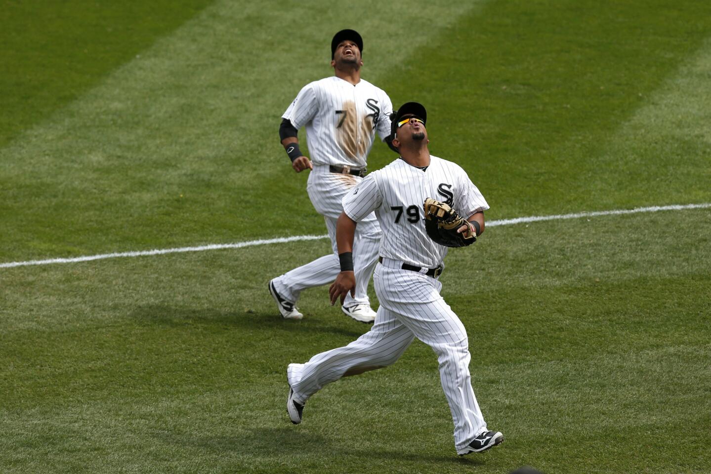 Jose Abreu and Micah Johnson look up for a ball hit in foul territory in the third inning.
