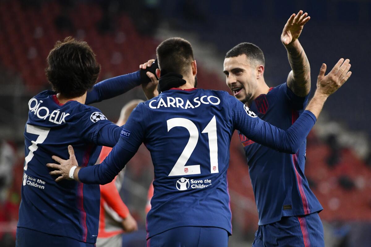 Atletico Madrid's Yannick Carrasco celebrates with Joao Felix and Mario Hermoso after scoring.