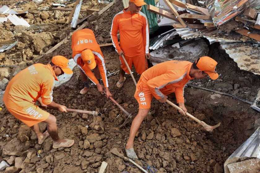 This photograph provided by India's National Disaster Response Force (NDRF) shows NDRF personnel trying to rescue those buried under the debris after a mudslide in Noney, northeastern Manipur state, India, Thursday, June 30, 2022. (National Disaster Reponse Force via AP)