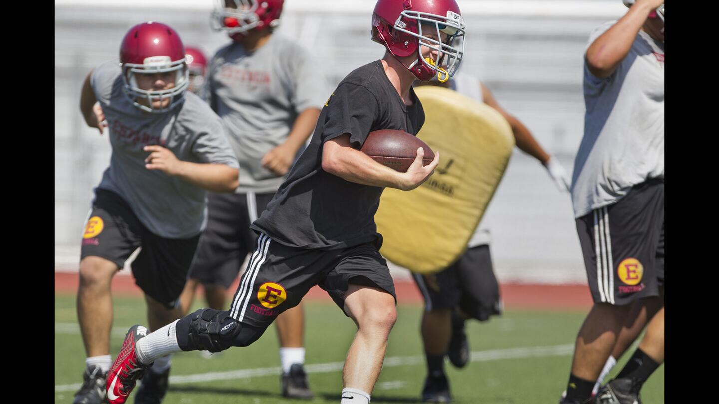 Estancia High running back Trevor Pacheco carries the ball during practice on Friday in Costa Mesa. (Kevin Chang/ Daily Pilot)