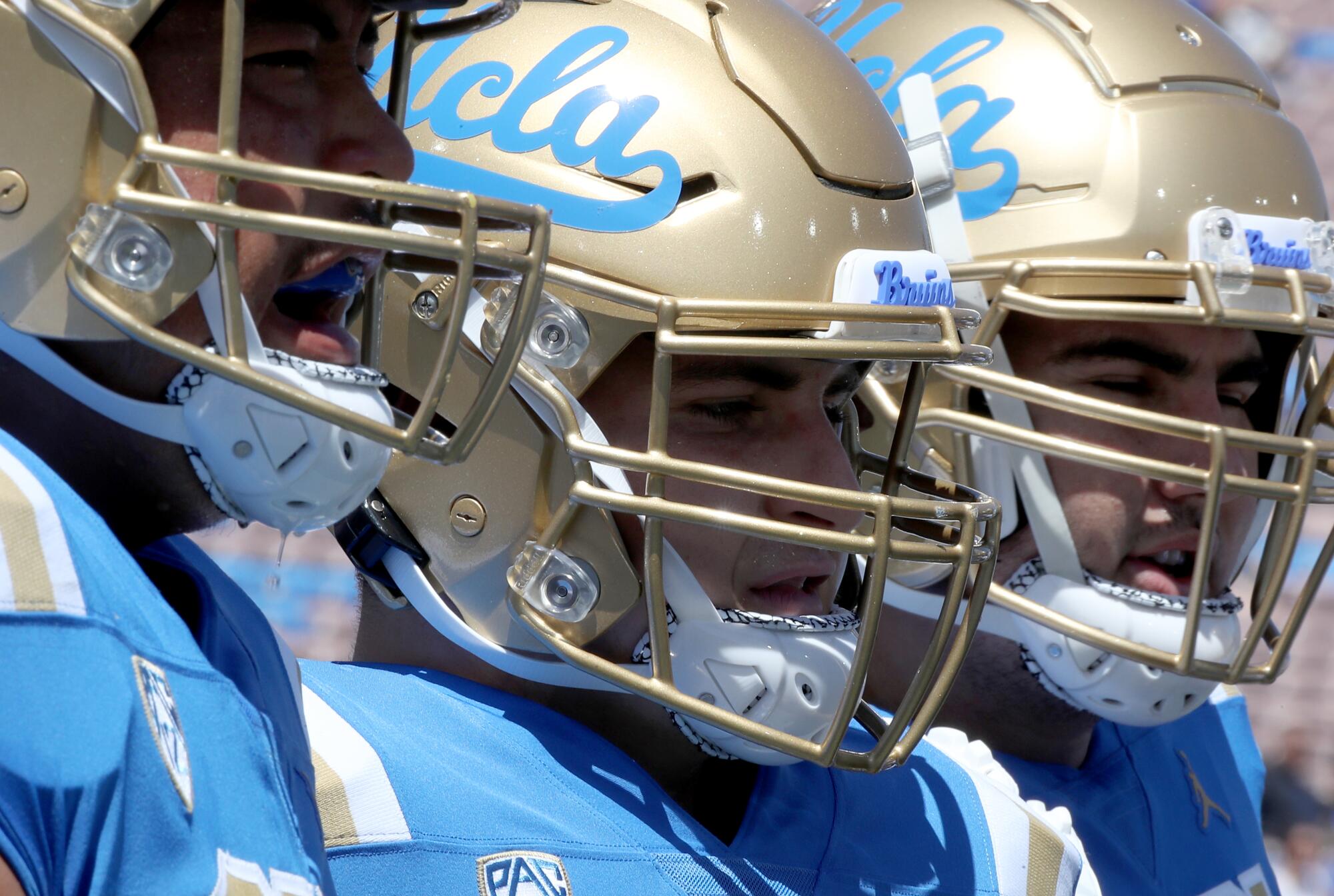 UCLA players take the field for a game against Hawaii at the Rose Bowl.
