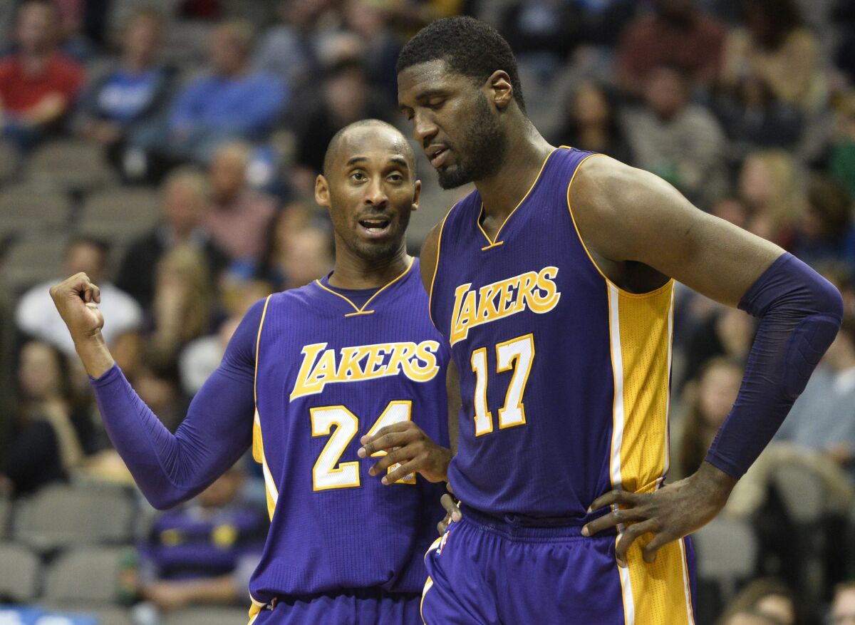 Lakers guard Kobe Bryant talks to center Roy Hibbert (17) after a foul in the second half.