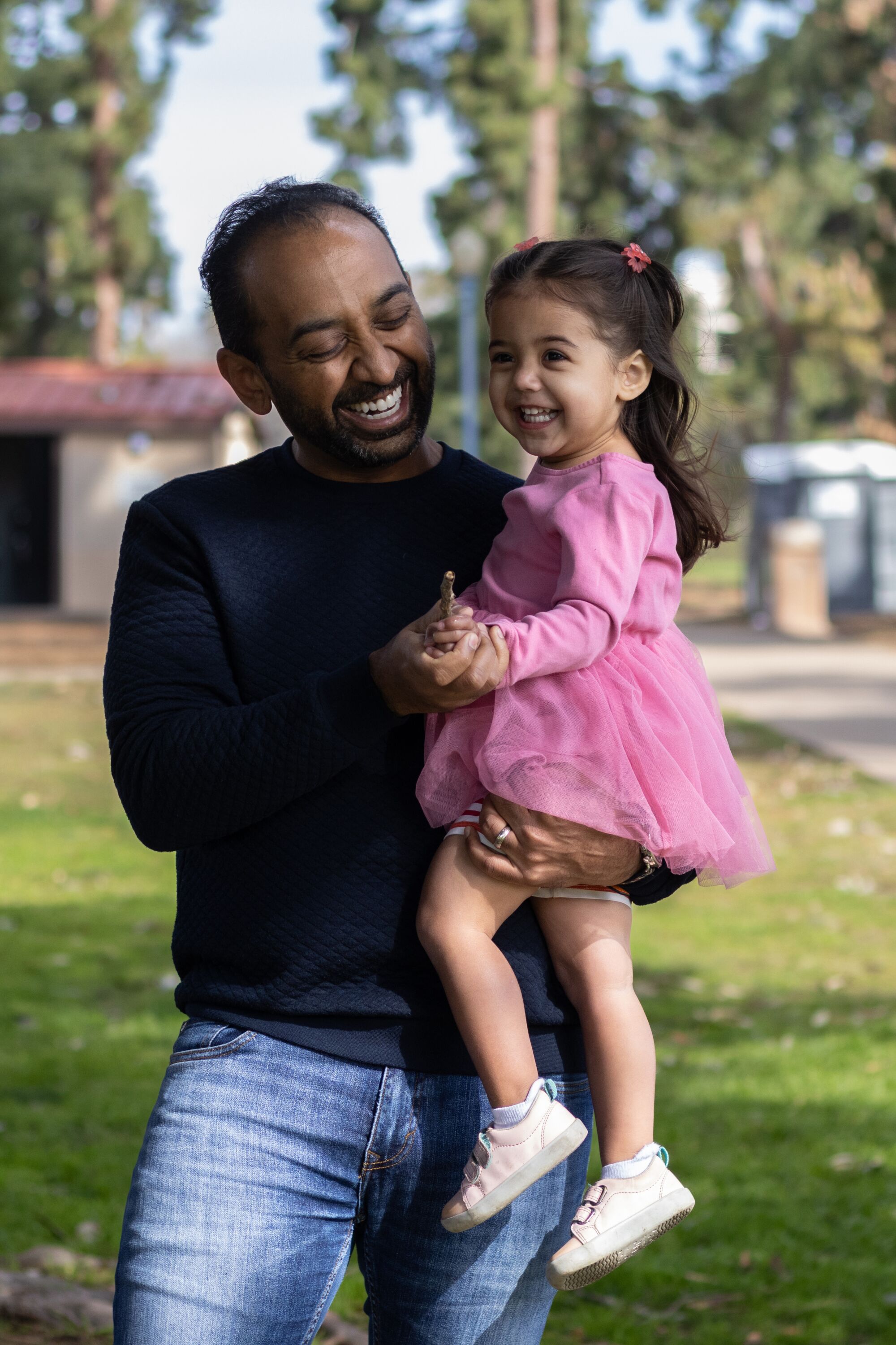 Sameer Patel helps his daughter, Veda, in Balboa Park.