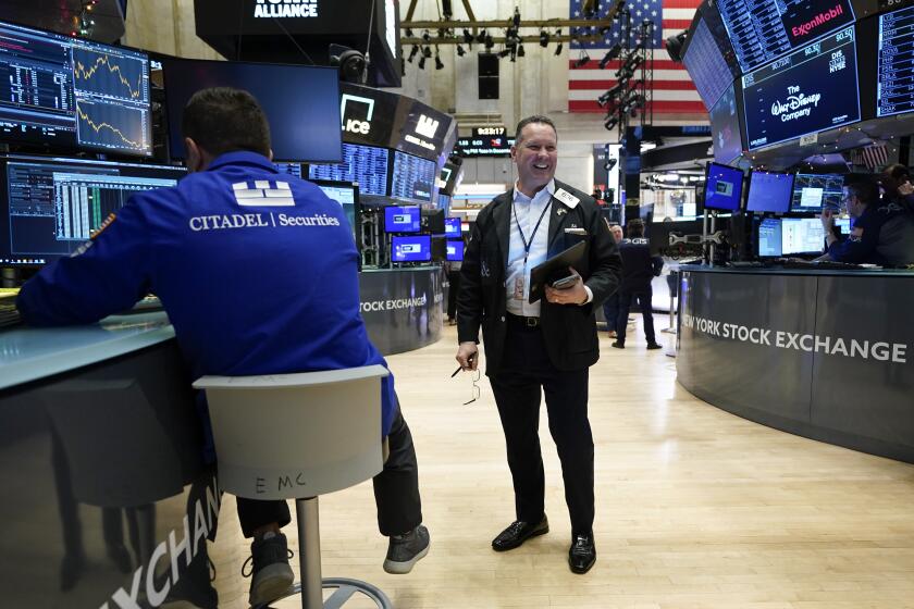 Traders work on the floor at the New York Stock Exchange in New York, Wednesday, Jan. 3, 2024. (AP Photo/Seth Wenig)