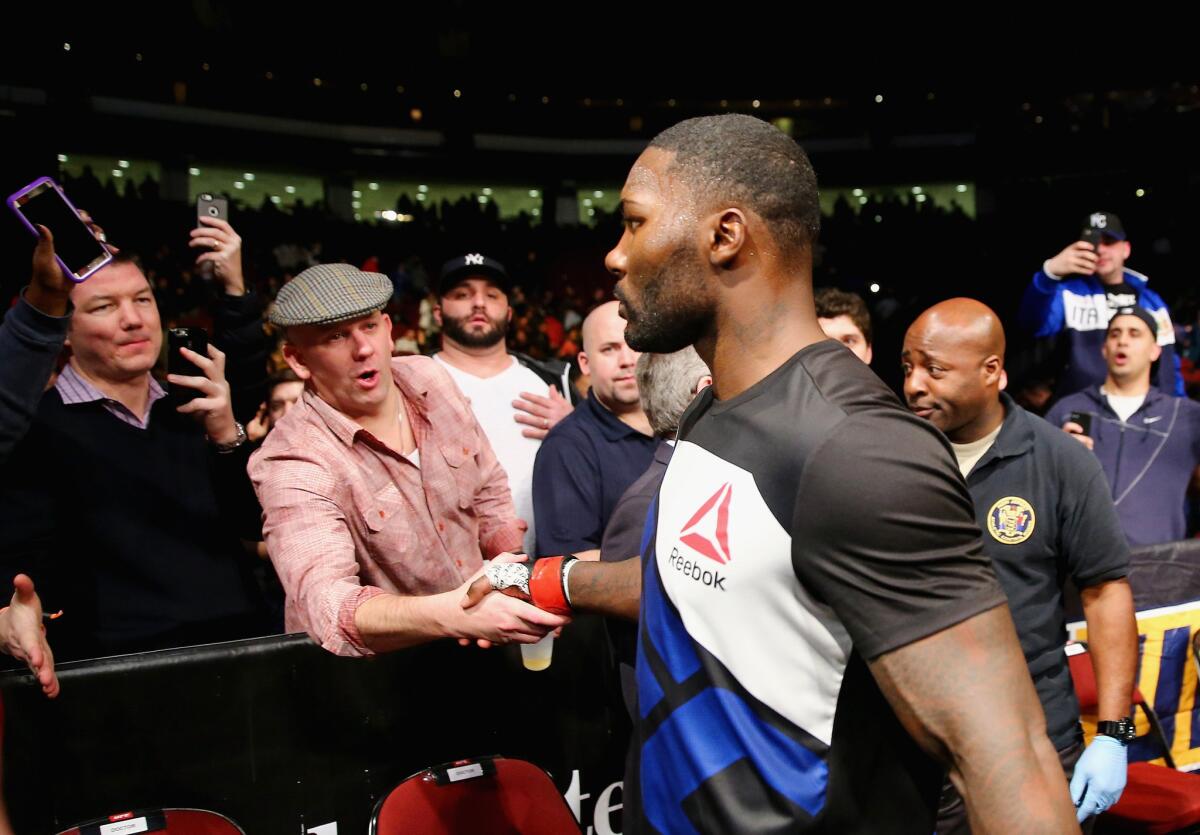 UFC fighter Anthony Johnson leaves the octagon after his TKO victory over Ryan Bader during a UFC Fight Night event on Saturday.