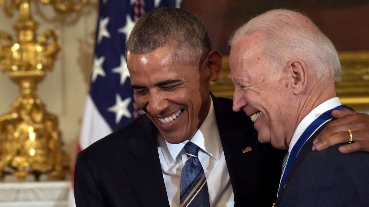 President Barack Obama laughs with Vice President Joe Biden during a ceremony in the State Dining Room of the White House in Washington on Jan. 12.