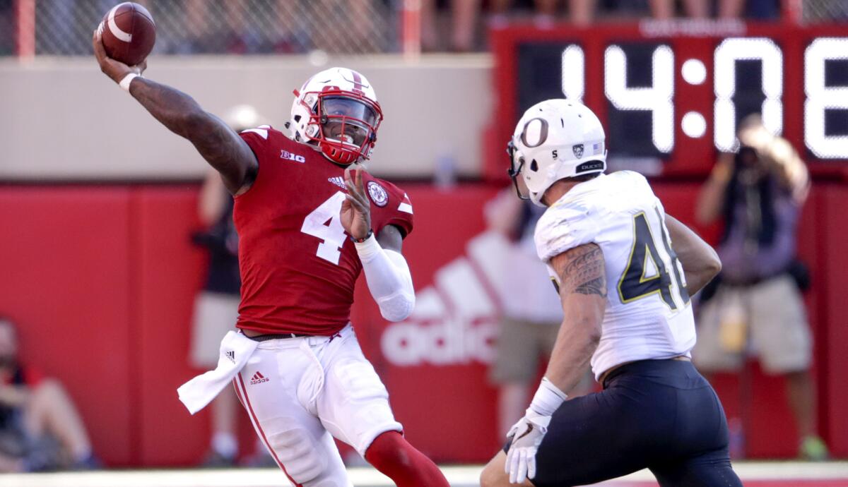 Nebraska quarterback Tommy Armstrong Jr. throws on the run while pressured by Oregon linebacker Danny Mattingly during the second half Saturday.