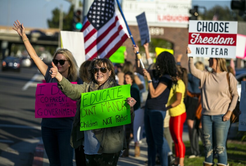 Karin Bates, left, and Patrice Murray participate in a rally.