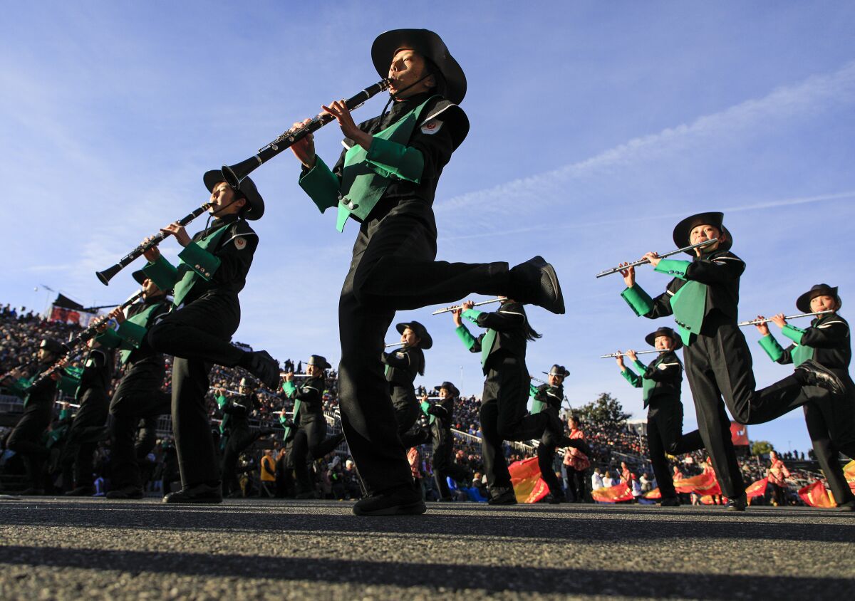 The Japan Honor Green Band dance their way down Colorado Blvd during the 2020 Rose Parade.