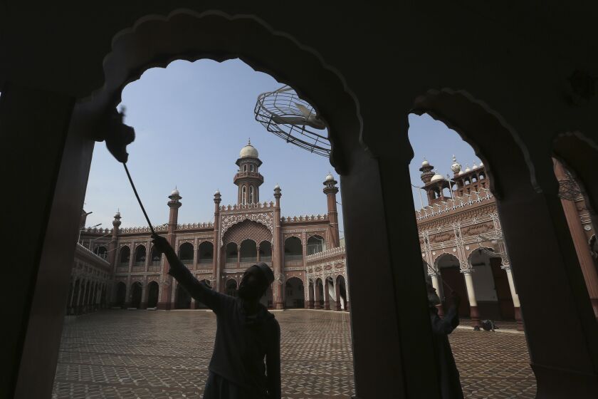 A worker cleans an area in the historical Sunehri mosque, ahead of the upcoming Muslim fasting month of Ramadan, in Peshawar, Pakistan, Wednesday, March 22, 2023. Muslims across the world will be observing the Ramadan, when they refrain from eating, drinking and smoking from dawn to dusk. Ramadan is expected to officially begin Thursday or Friday in Pakistan, though the timing depends on the alignment of the moon. (AP Photo/Muhammad Sajjad)
