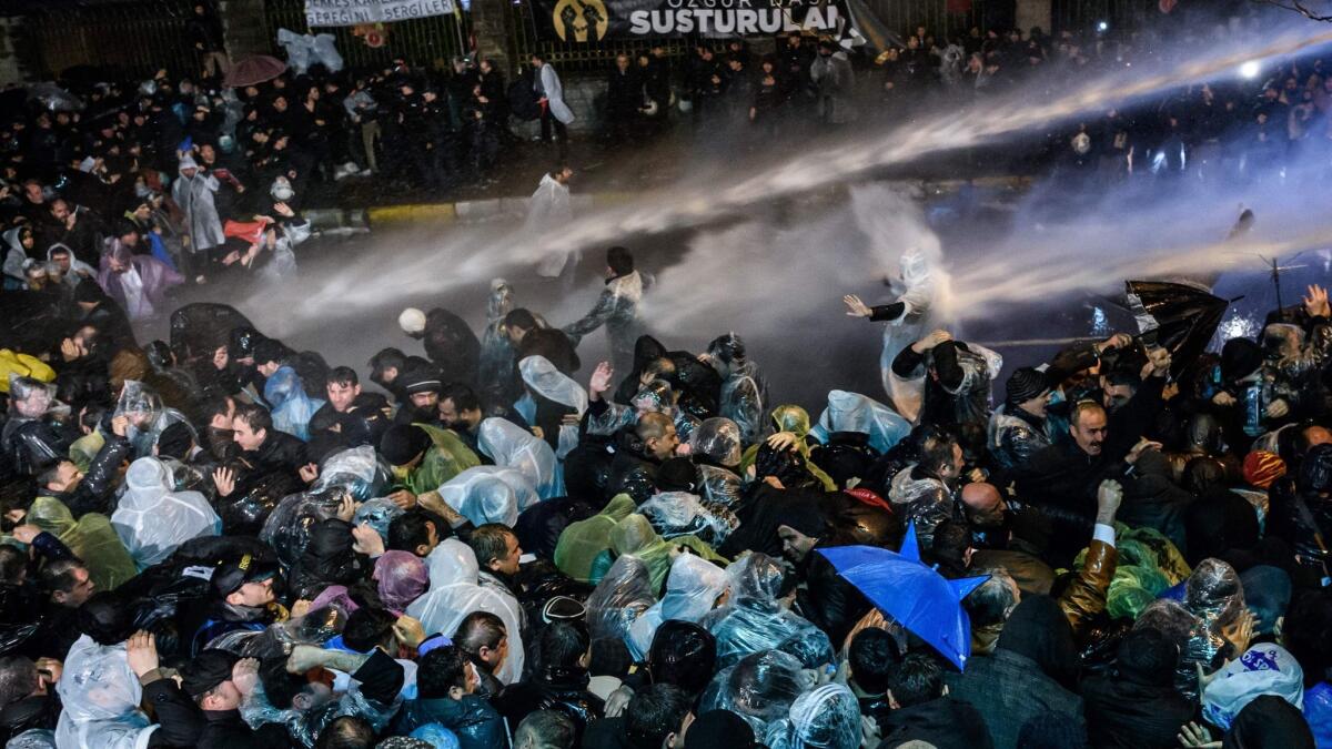 Turkish riot police use water cannon and tear gas to disperse supporters at the Zaman daily newspaper's headquarters in Istanbul on March 5, 2016.