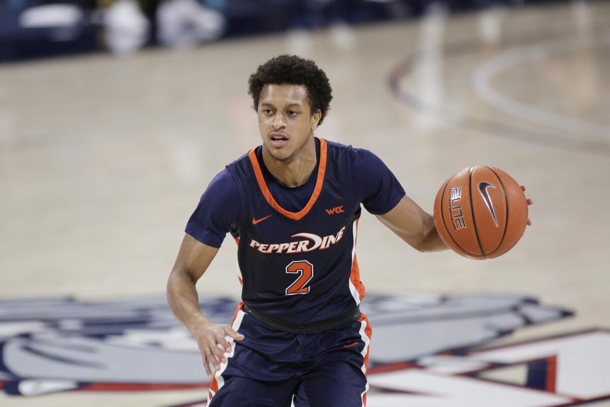 Pepperdine guard Darryl Polk Jr. dribbles the ball.