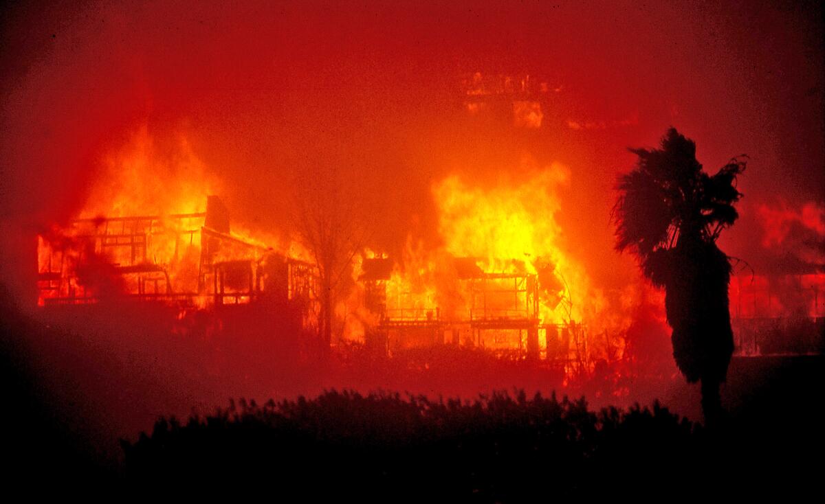 Homes in Emerald Bay are fully engulfed in flames during the Laguna Beach wildfire blaze of October 1993.