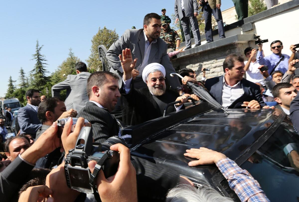 Iranian president Hassan Rouhani waves to journalists and supporters upon his return to Tehran from New York in September.