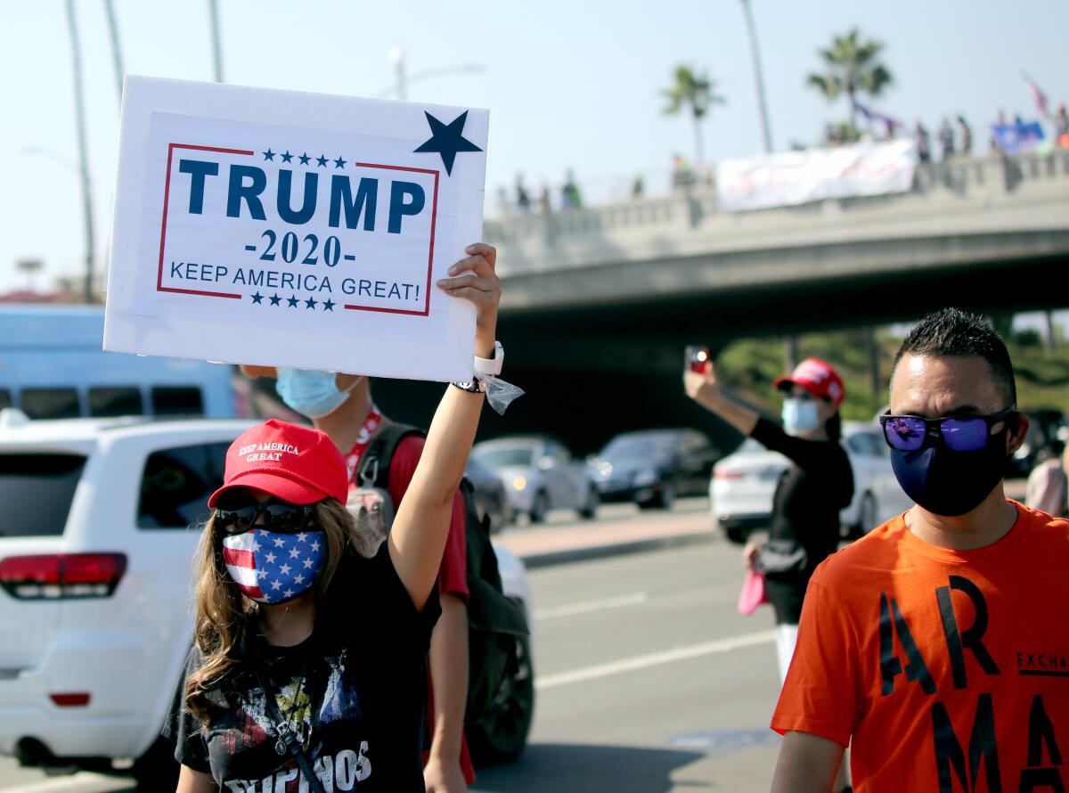 Trump supporters walk on Pacific Coast Highway in Newport Beach.