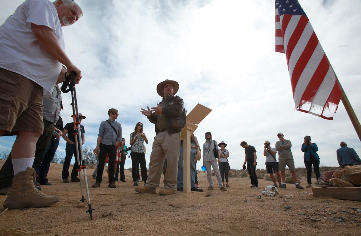 Peter Merlin, center, and Tony Moore, left, at a memorial to the crew of an ill-fated YB-49 test flight near Mojave. The X-Hunters scour the Mojave Desert looking for the wreckage of some of the most famous aircraft crashes in aviation history.
