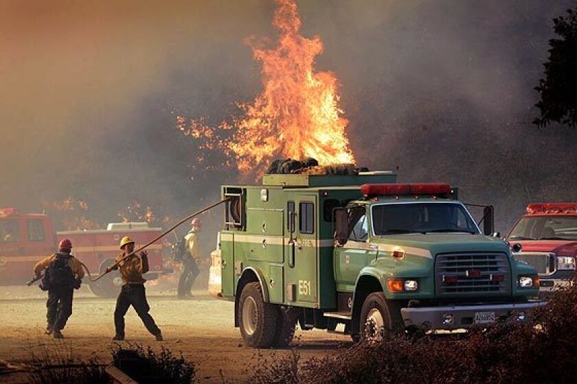 Forest Service firefighters try to contain flames from the Station Fire as it jumps Angeles Crest Highway.