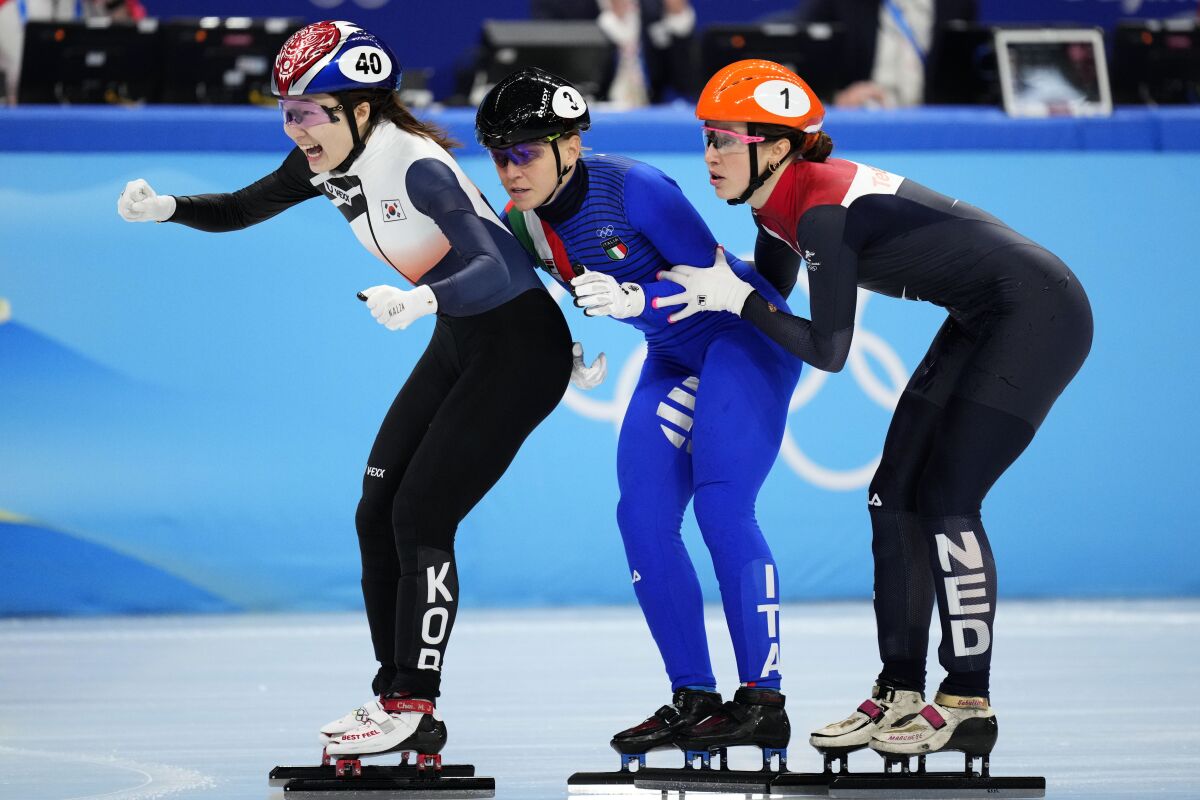 Choi Min-jeong, left, of South Korea, crosses the finish line ahead of Arianna Fontana of Italy, Suzanne Schulting, right, of the Netherlands, in the women's 1500-meters final during the short track speedskating competition at the 2022 Winter Olympics, Wednesday, Feb. 16, 2022, in Beijing. (AP Photo/Bernat Armangue)