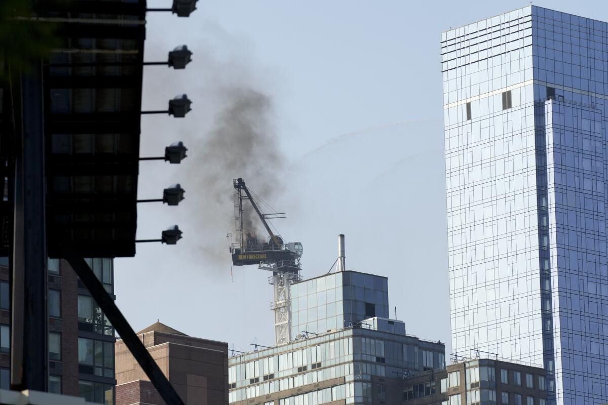 Smoke rises from a construction crane that caught fire in Manhattan. 