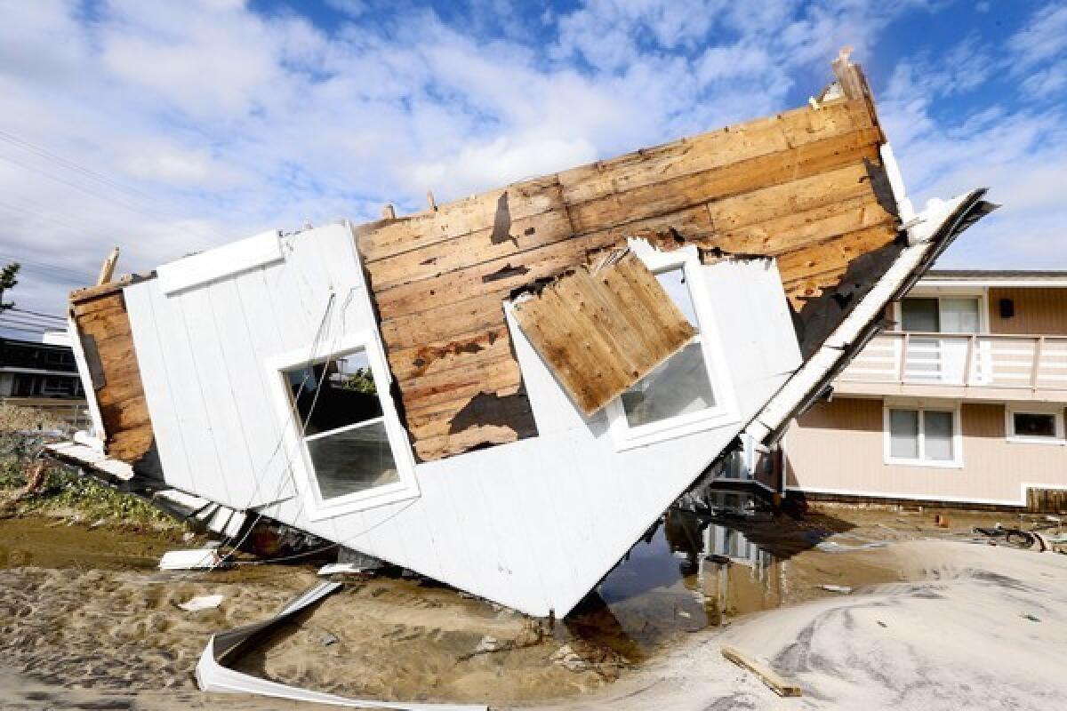Part of a home rests upside-down in Seaside Heights, N.J. on Oct. 31 after superstorm Sandy made landfall in New Jersey. The rest of the home sat away from its original spot and in the middle of a street.
