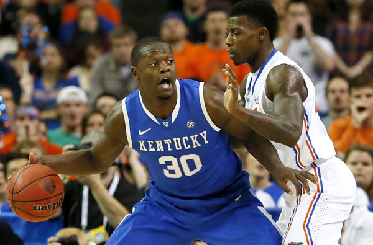 Kentucky forward Julius Randle works in the post against Florida forward Casey Prather during the SEC tournament championship game on March 16.