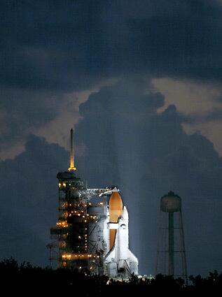 Just before sunrise at the Kennedy Space Center in Cape Canaveral, Fla., NASA fuels Space Shuttle Discovery in preparation for its Independence Day launch.