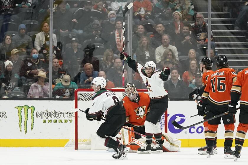 The Arizona Coyotes' Clayton Keller (9) celebrates after scoring the winning goal during overtime against the Ducks.