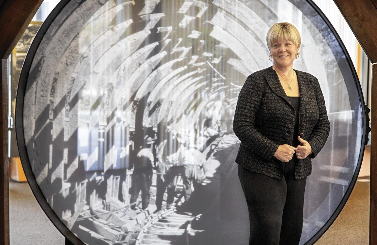 New DWP General Manager Marcie Edwards, in front of an image of the California Aqueduct being built, climbed the ladder at the agency for 24 years early in her career before heading for work in Orange County.