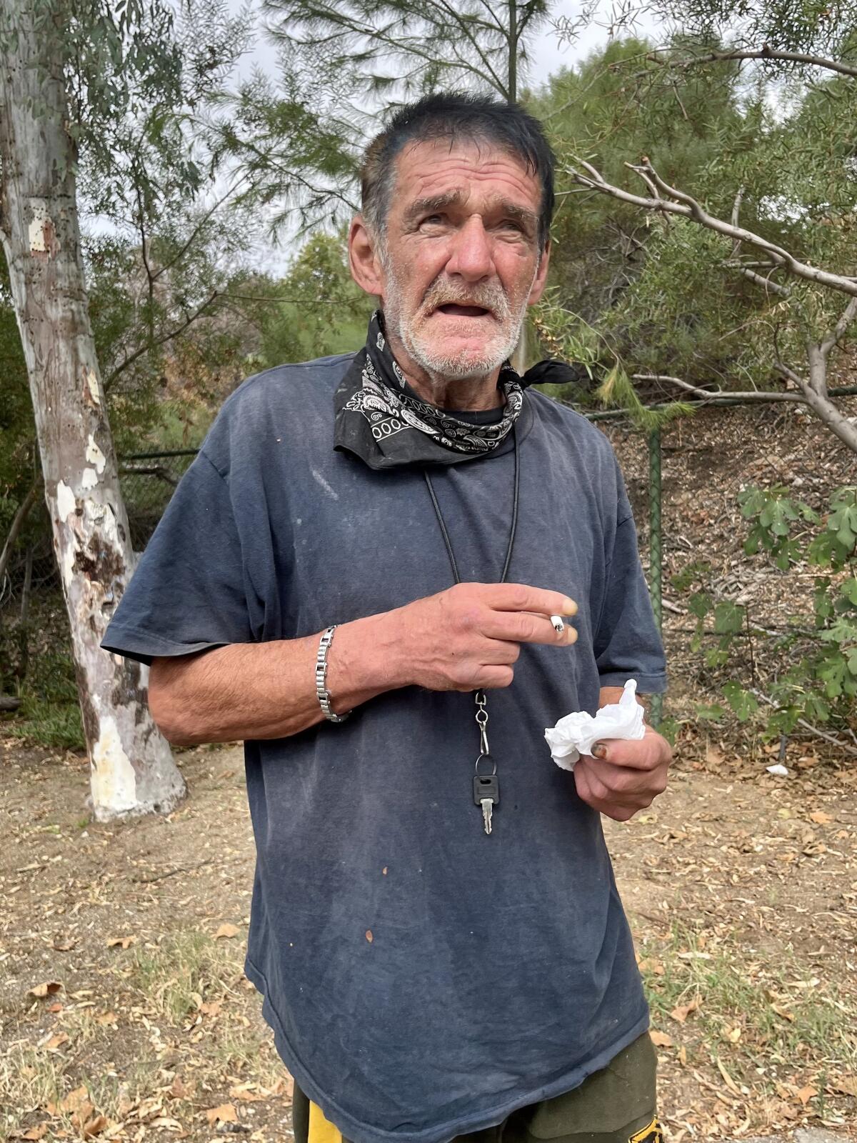 A man smokes a cigarette outdoors