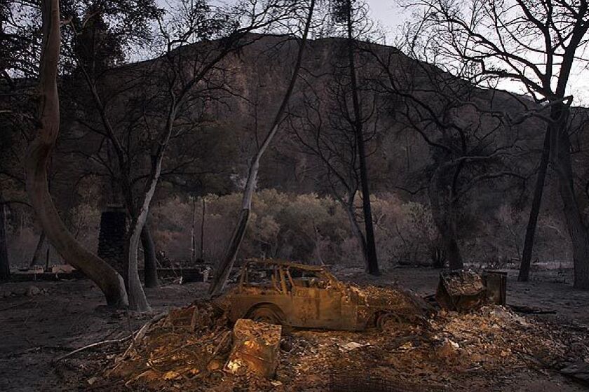 An incinerated car sits in the devastated hamlet of Vogel Flats, which is along Big Tujunga Canyon Road in the Angeles National Forest.