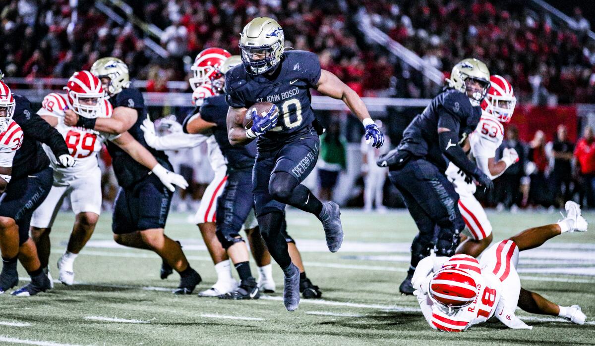 St. John Bosco High running back Cameron Jones bursts through the Mater Dei defensive line.