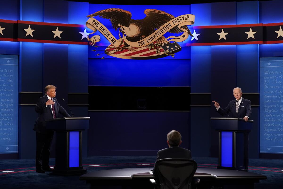 President Trump, left, and Joe Biden, right with moderator Chris Wallace, during the first presidential debate