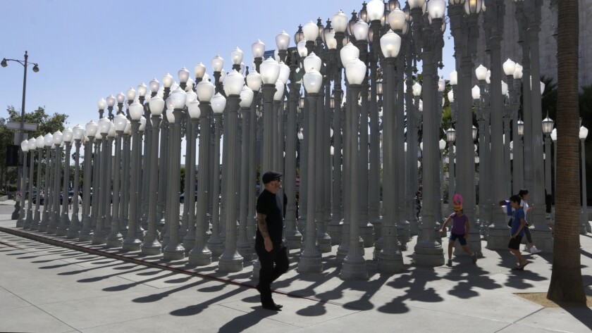 Visitors to the L.A. County Museum of Art view the "Urban Light" installation by artist Chris Burden.