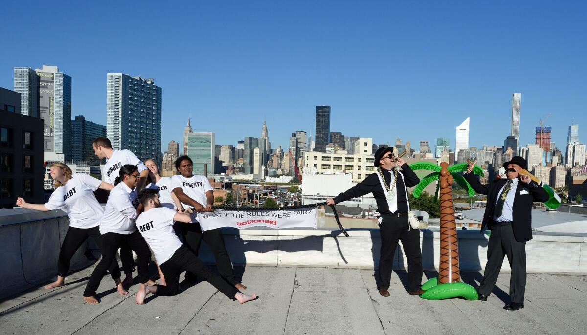 Actors from a group called ActionAid stage a tug-of-war between the rich and the poor to depict the world's struggle against inequality on Sept. 24 in New York City.
